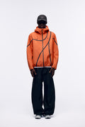 Ventarra unisex hooded shell jacket in Orange — waterproof 3-layer composite with asymmetric external tape strips and adjustable hood